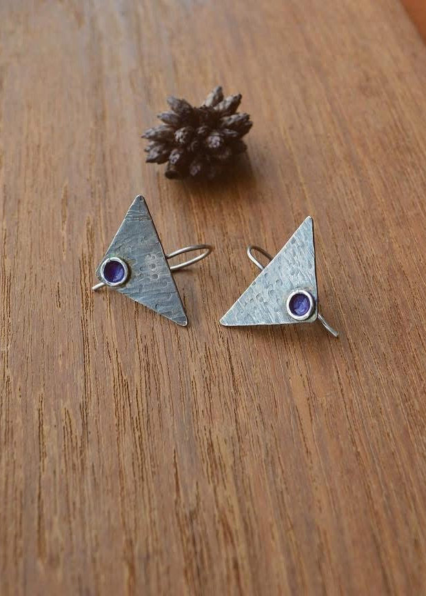 Pair of silver triangle-shaped earrings with purple patina.